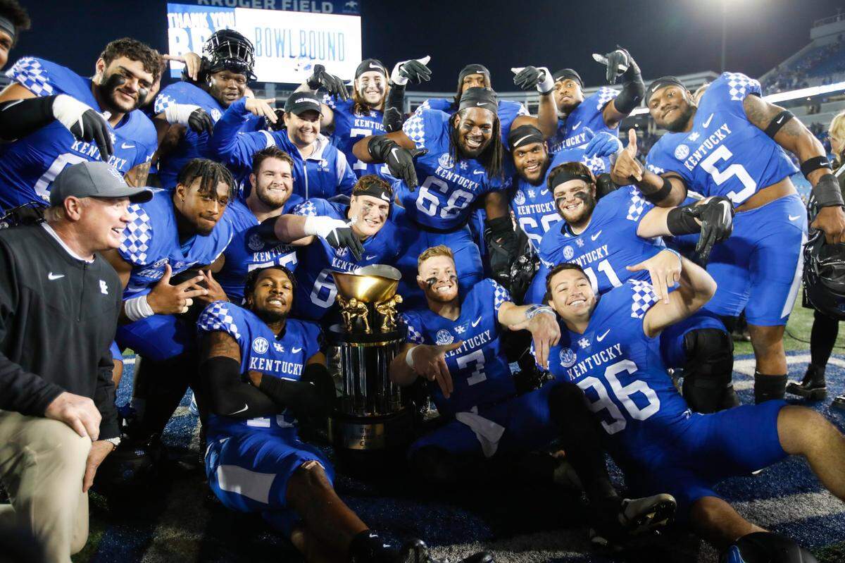 The Kentucky Wildcats celebrates defeating the Louisville Cardinals 26-13 to win during the Governor’s Cup at Kroger Field in Lexington, Ky., Saturday, November 26, 2022.
