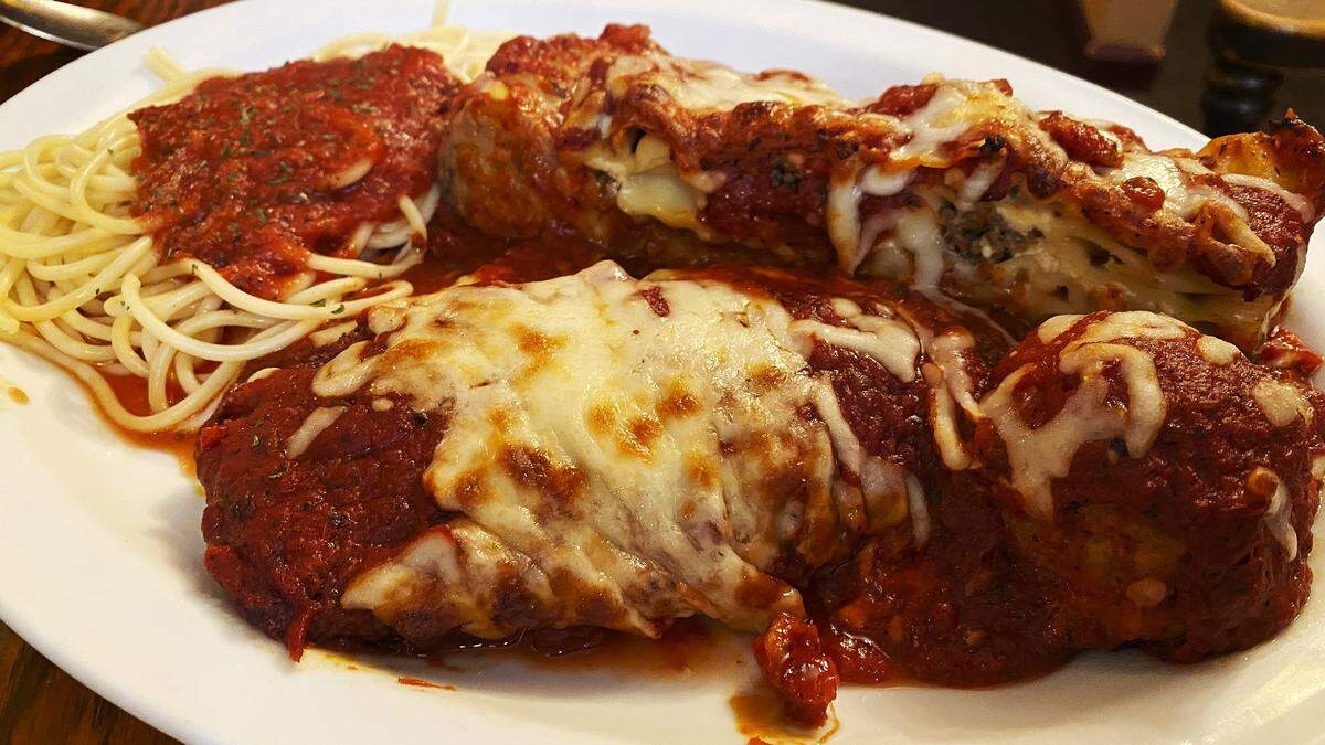 The Paisano’s Sampler at Paisano’s Italian Restaurant & Lounge includes fan favorites chicken Parmesan, lasagna, Italian sausage and meatballs. The dish is served with spaghetti.