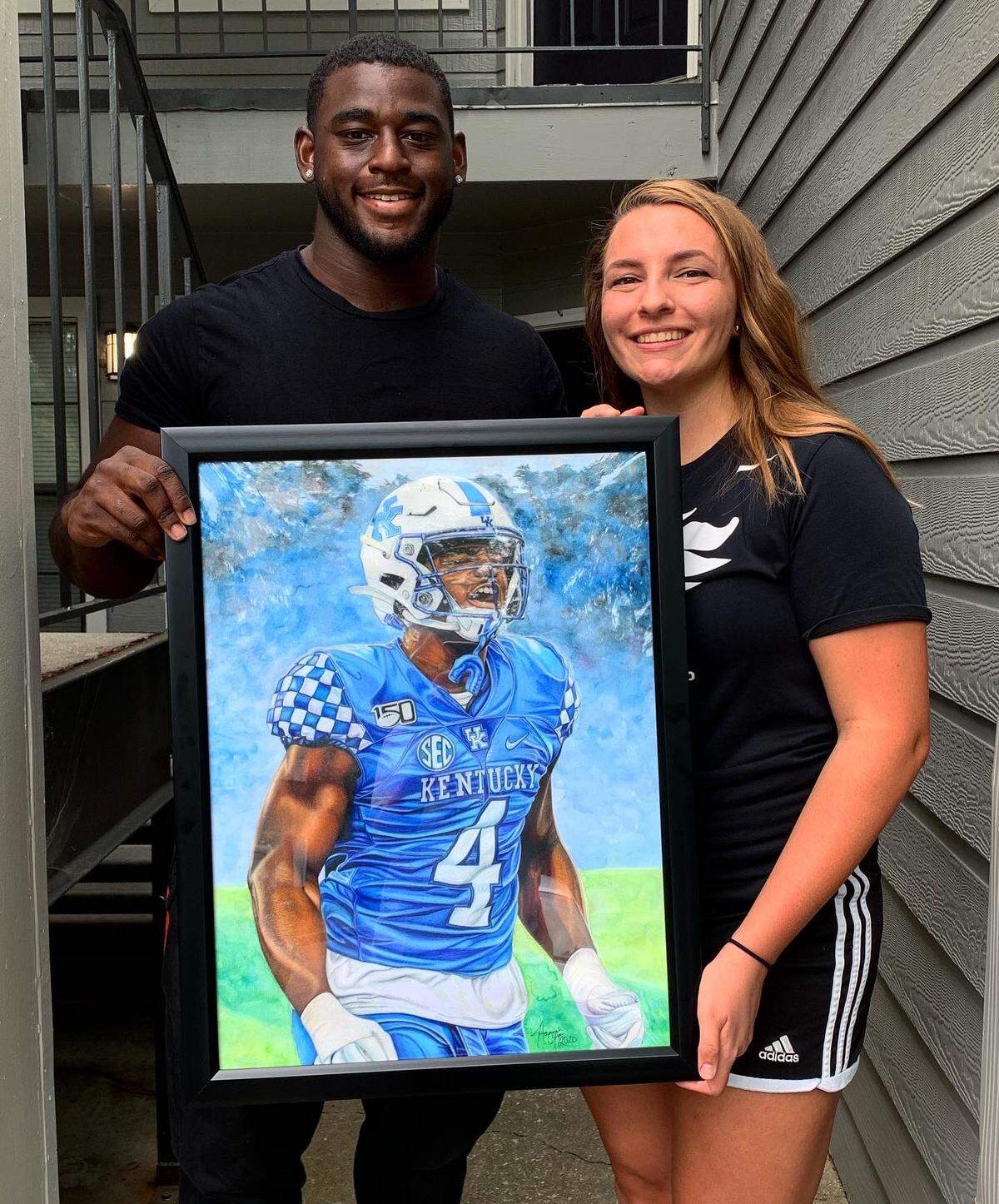 Kentucky football player Josh Paschal, left, commissioned a piece of himself from Hannah Clayton, an athletic trainer at Scott County High School and a UK grad student.