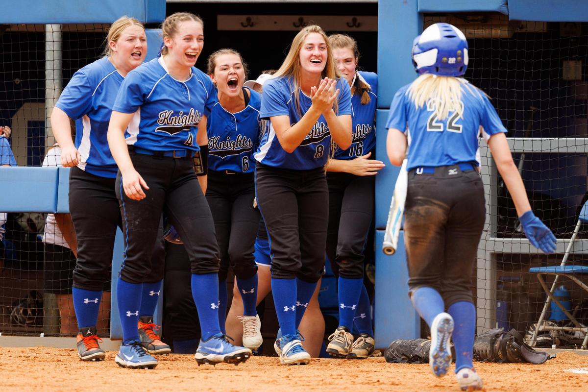 Teammates cheer for Lexington Catholic’s Lucy Nash (22) after she hit an inside-the-park home run against Harrison County in the state softball quarterfinals on Friday.