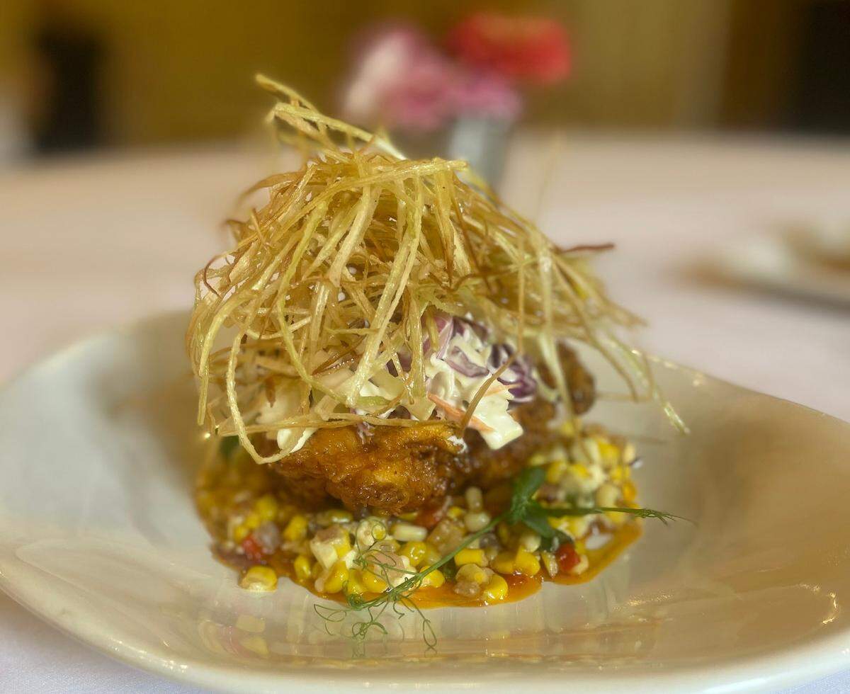 Fried Chicken with buttermilk rind fried hot chicken, corn tomato relish, cabbage, slaw and fried leeks at Castle Farm at The Kentucky Castle.