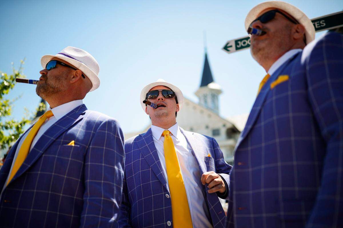Andy Bush, Jacob Bush, and Bill Bush, all of Baton Rouge, La., dressed in support of the LSU tigers at the Kentucky Derby.