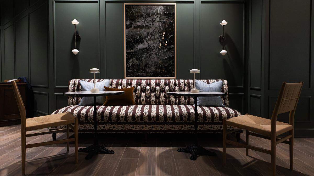 A posh sitting area with a classic tufted back, natural materials, and a stylish palette in the lounge area of the PNC Bank branch office, currently undergoing renovations at 325 West Main on May 20, 2026. 