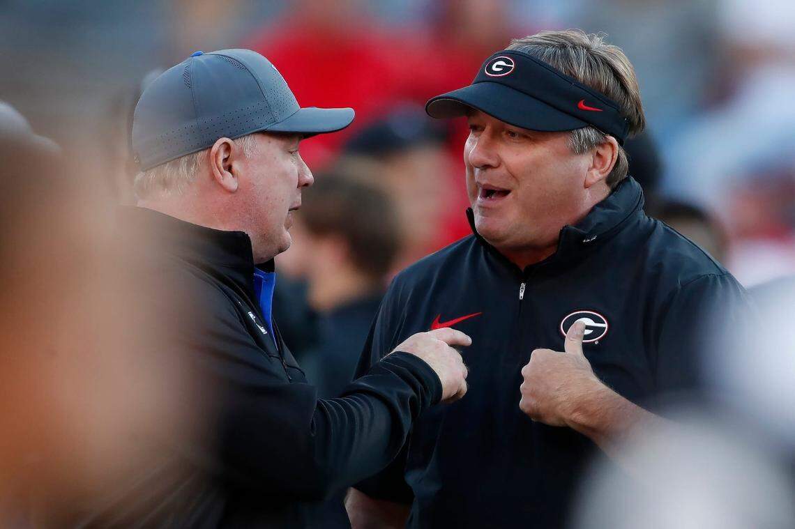 Georgia coach Kirby Smart, right, spoke with Kentucky coach Mark Stoops prior to the Bulldogs’ 51-13 rout of the Wildcats last season in Athens. Georgia has beaten Kentucky in 14 straight meetings between the teams.