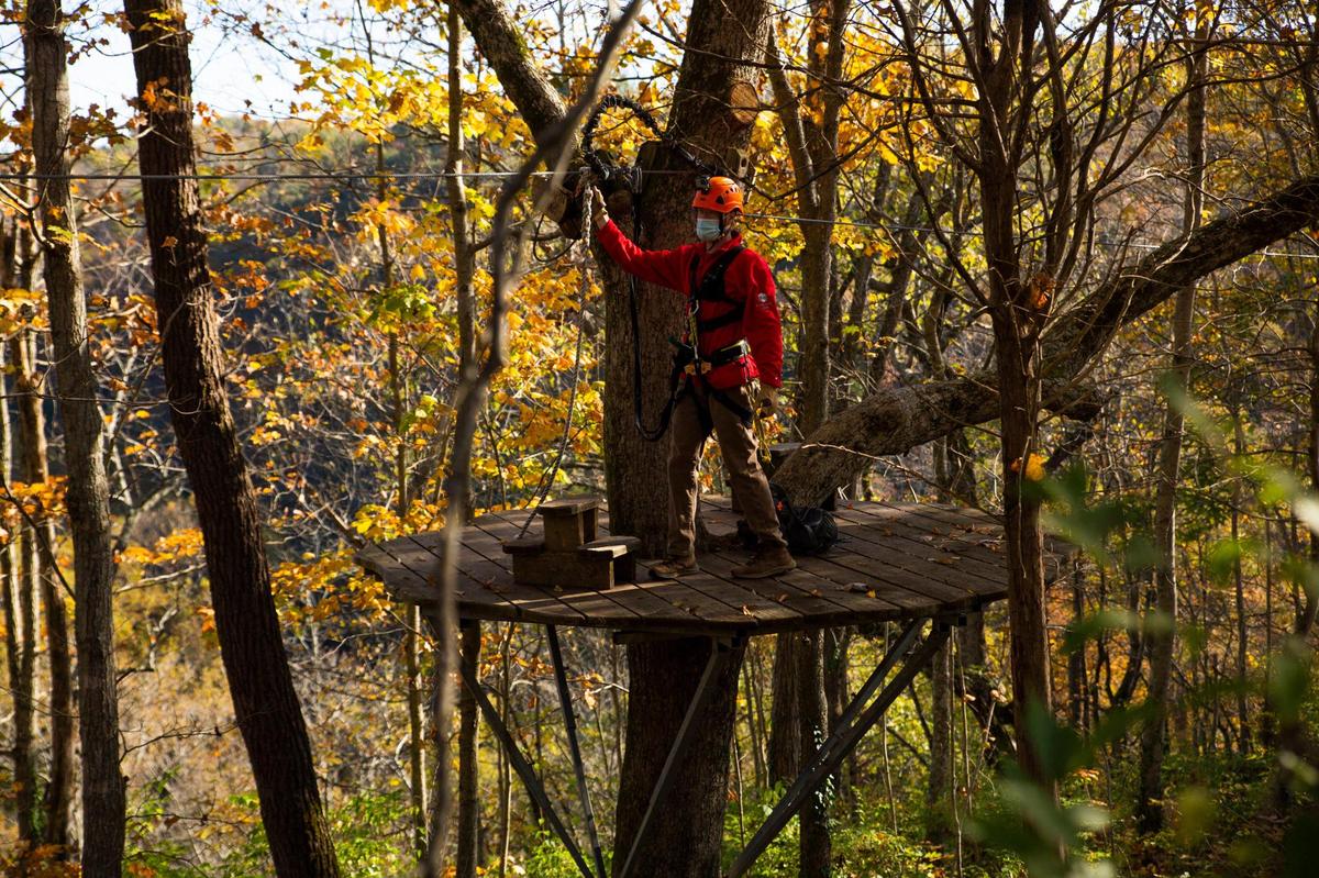 Adam Downs, manager and guide at Boone Creek Outdoors, prepares the zip line for a tour on Saturday, Oct. 17, 2020, in Lexington, Ky.