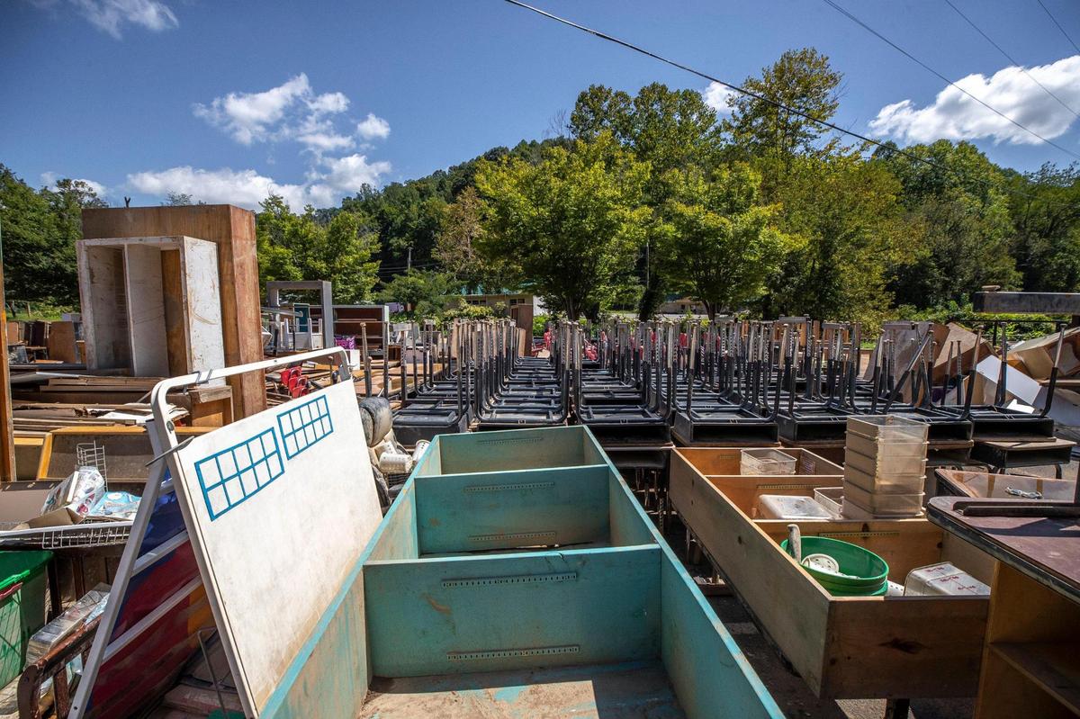 Chairs, desks and other school furniture sit outside Martha Jane Potter Elementary School in Kona, Ky., on Wednesday, Aug. 31, 2022. The school was damaged by flooding in late July.