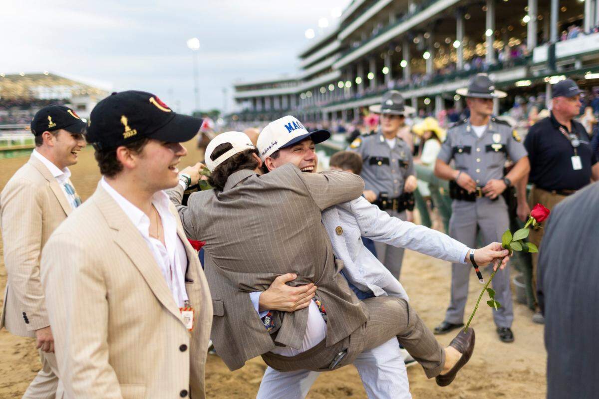 Some of Mage’s many connections celebrate after their colt won the 149th running of the Kentucky Derby at Churchill Downs.