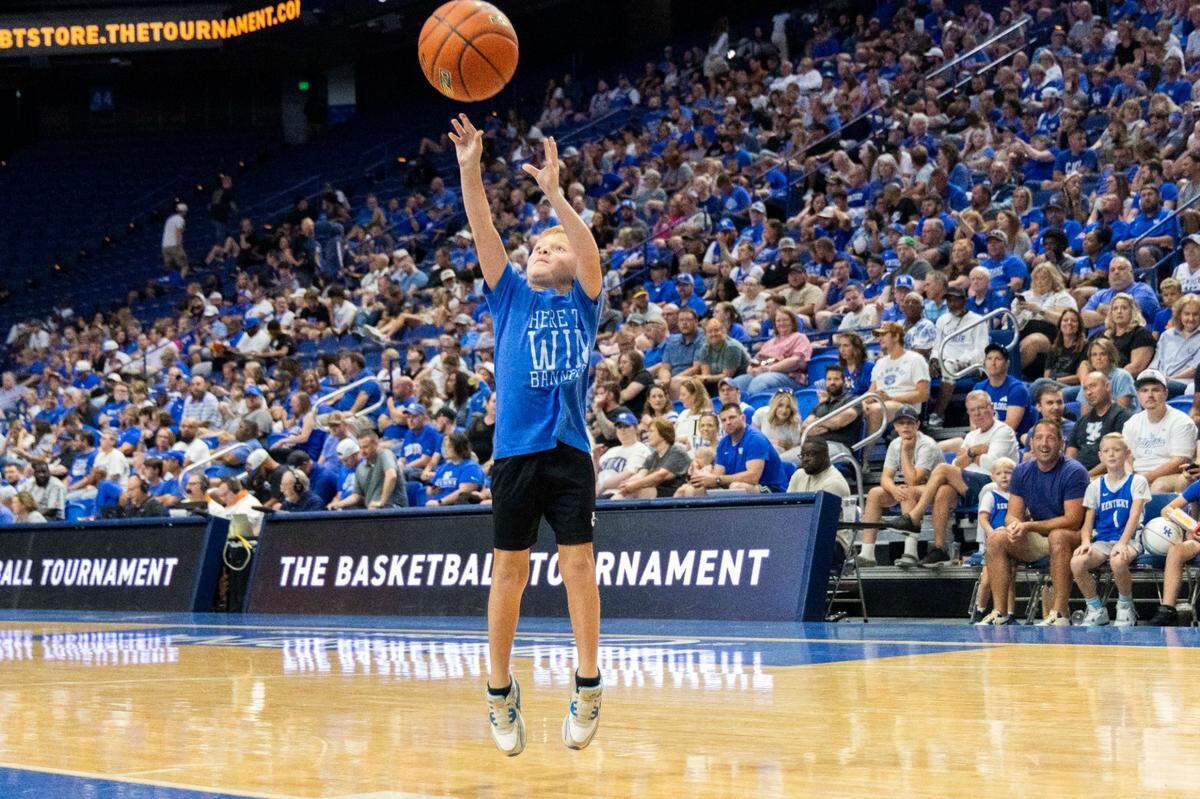 A young fan puts up a shot during a timeout in Rupp Arena on Friday night.
