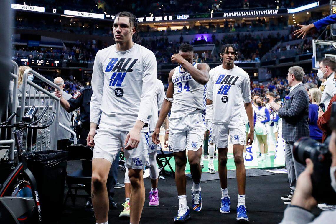 Kentucky players, from left, Lance Ware, Oscar Tshiebwe and Daimion Collins walk off the court at Gainbridge Fieldhouse in Indianapolis after their loss to Saint Peter’s in the 2022 NCAA Tournament.