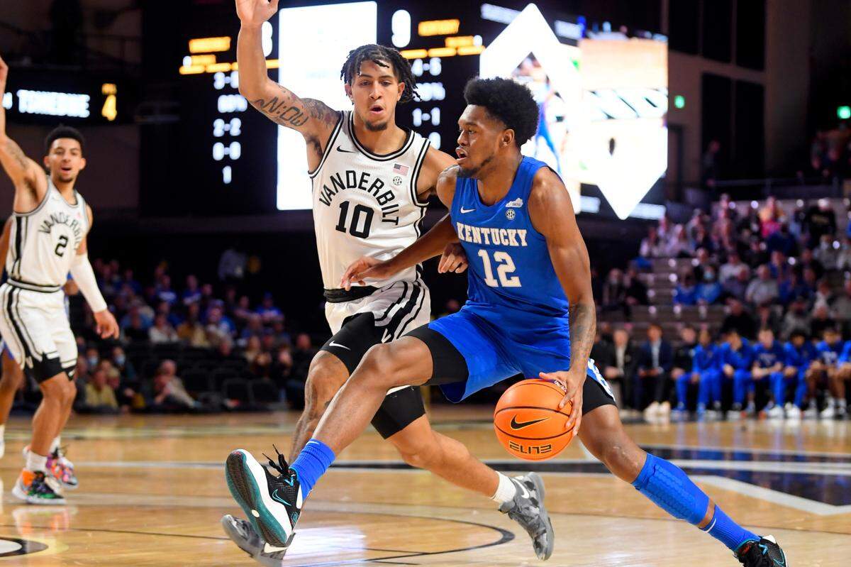 Kentucky forward Keion Brooks Jr. (12) drives as Vanderbilt forward Myles Stute (10) defends during the first half of an NCAA college basketball game Tuesday, Jan. 11, 2022, in Nashville, Tenn. (AP Photo/John Amis)