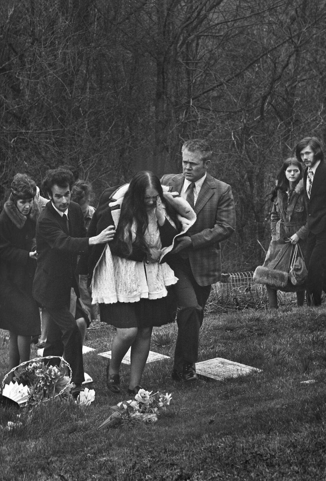 A Scotia widow leaves a mountainside grave site.