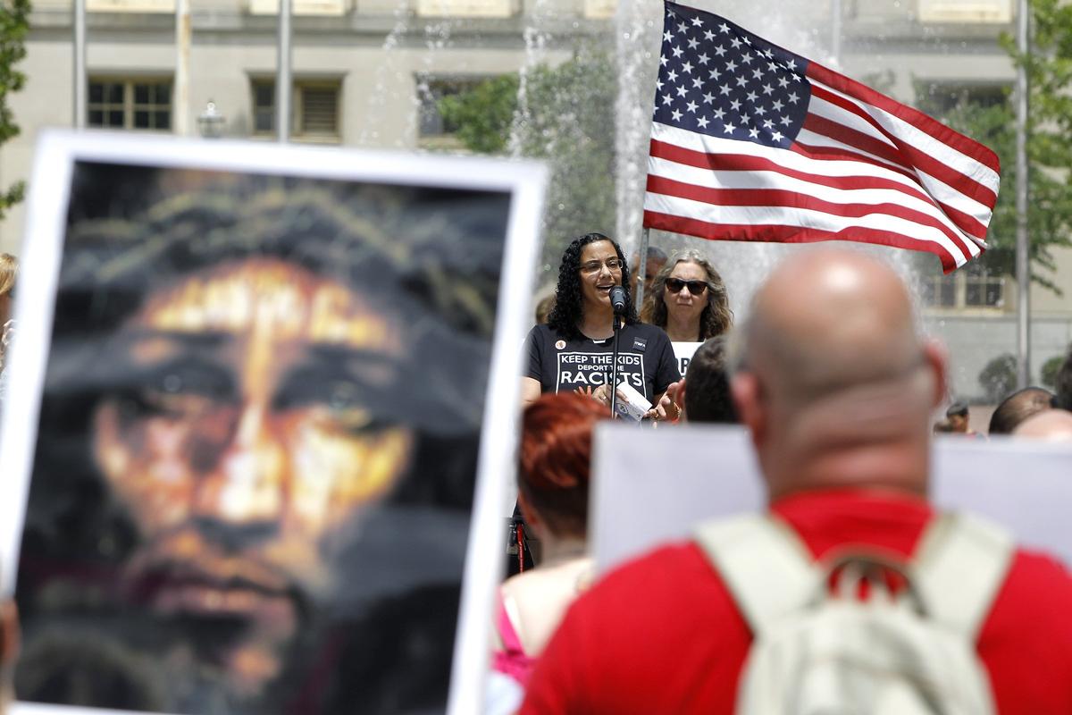 Faith Evans, a Moroccan immigrant who is now a U. S. citizen, spoke Saturday during the Keep Families Together Rally, presented by Kentucky NOW, at Courthouse Plaza in Lexington, KY.