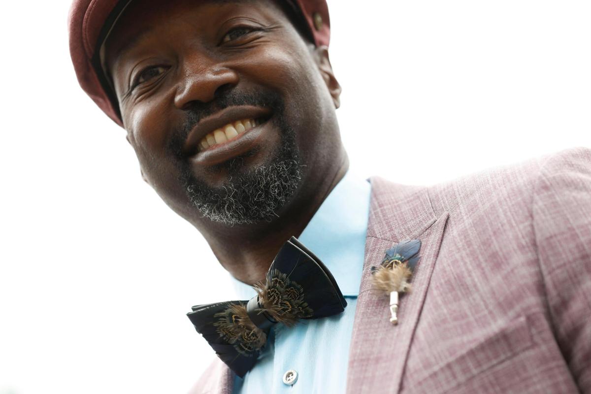 Marcus Stevenson, from Houston, wears a matching feather bow tie and boutonniere at Churchill Downs in Louisville, Ky., Saturday, May 7, 2022.