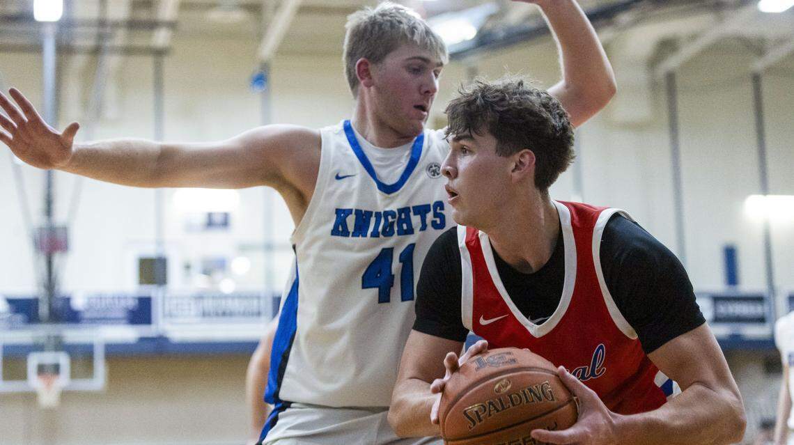 Madison Central's Jake Feldhaus (20) drives on Lexington Catholic's Hank Woodall (41) during the Knight’s 60-56 win over the Indians on Monday at Lexington Catholic High School.