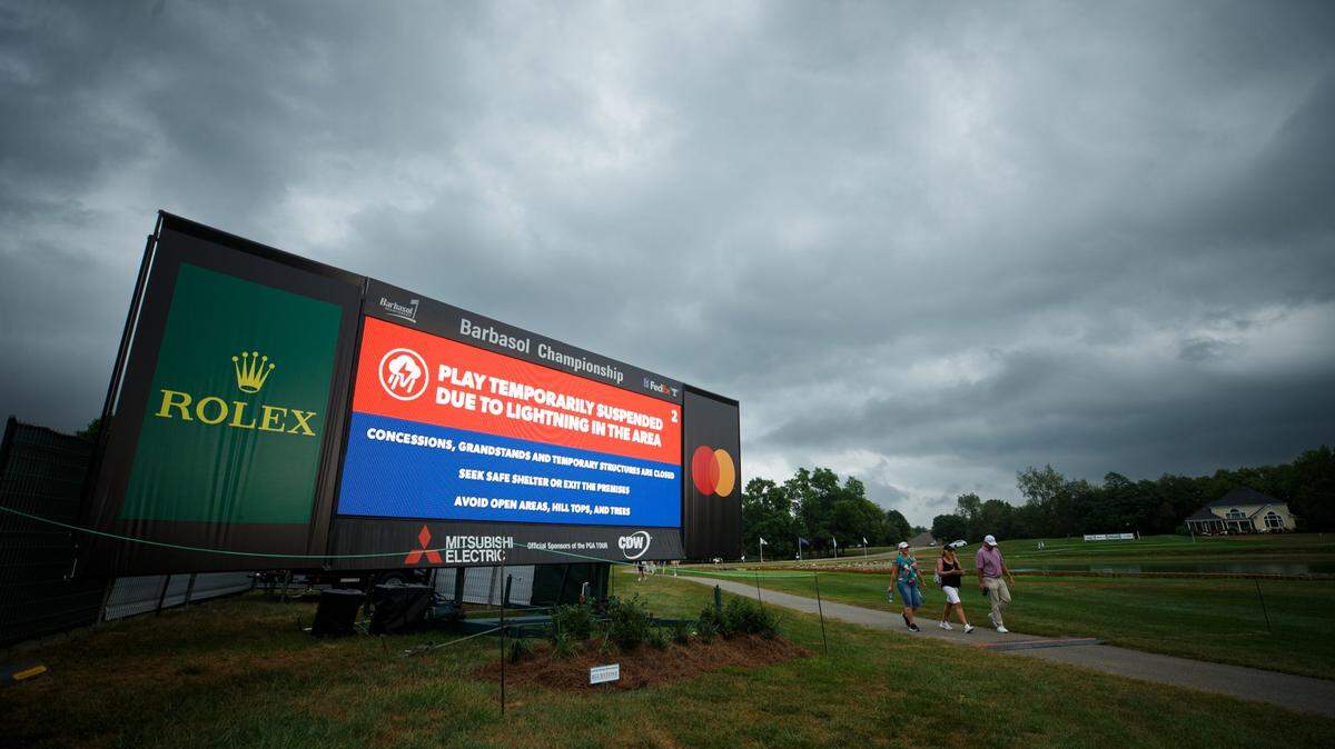Spectators walk off the course after play was suspended due to weather during the second round of the PGA Barbasol Championship on Friday at Keene Trace Golf Club in Nicholasville.