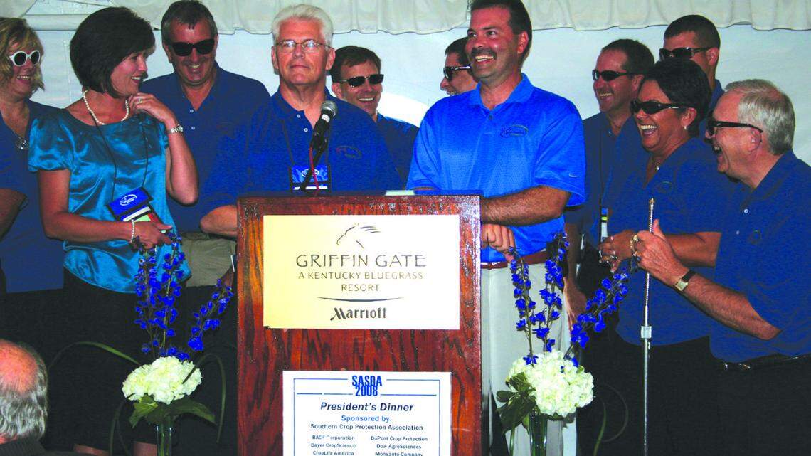 Agriculture staff members surprised Farmer, center, with a framed print at the end of the 2008 Southern Association of State Departments of Agriculture meeting in Lexington.