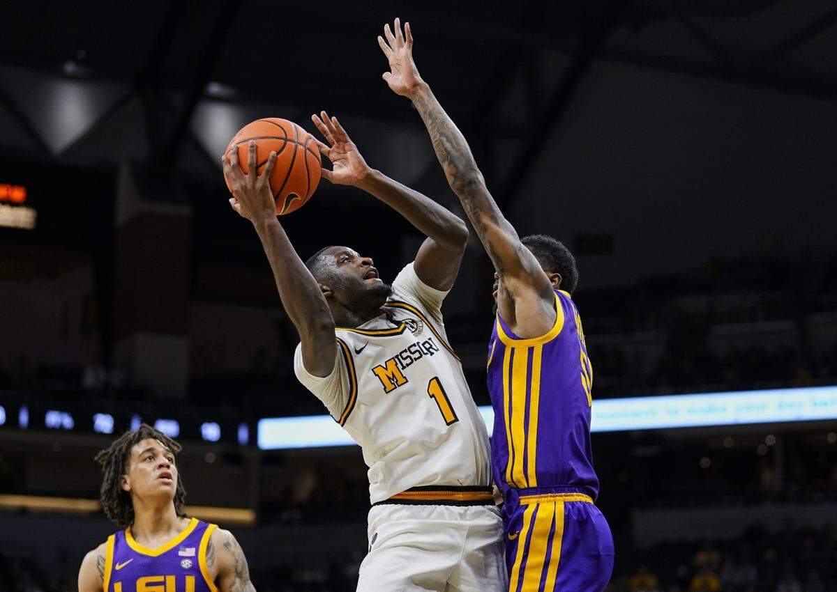 Jan 7, 2025; Columbia, Missouri, USA; Missouri Tigers guard Marques Warrick (1) goes up for a shot against LSU Tigers guard Cam Carter (5) during the first half at Mizzou Arena. Mandatory Credit: Jay Biggerstaff-Imagn Images