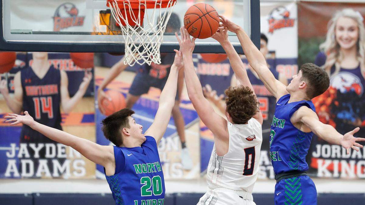 North Laurel’s Chase Keen (20) and Reed Sheppard (3) blocked Madison Southern’s Trent DeVries (0) at the rim during their game at Madison Southern High School last month. North Laurel beat Madison Southern 82-58.