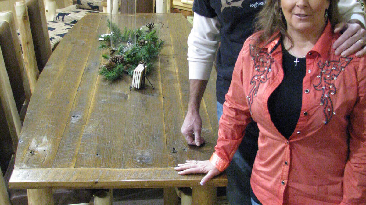 Tommy and Gwen Mitchell, founders of Rocky Top Log Furniture & Railing, have landed a TV show pilot based on their log furniture company in Garrard County. The dining room table is one of their products. 