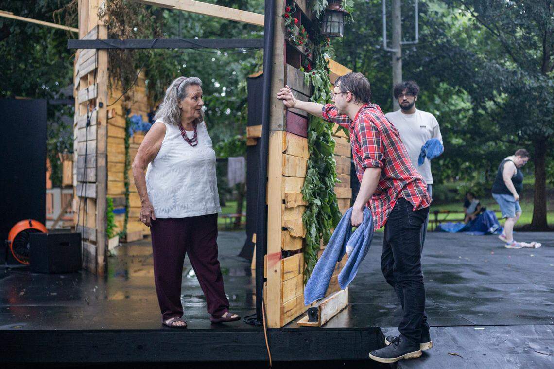Triton Blackburn, right, talks with a member of the stage crew before a showing of Romeo and Juliet on Friday, July 18, 2025, at Woodland Park in Lexington, Ky.