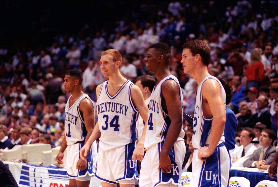 John Pelphrey (34) and fellow University of Kentucky basketball players Sean Woods, left, Jamal Mashburn, center, and Deron Feldhaus, right watched as the final seconds ticked off of UK’s 80-54 win over Alabama in the finals of 1992 SEC Tournament.