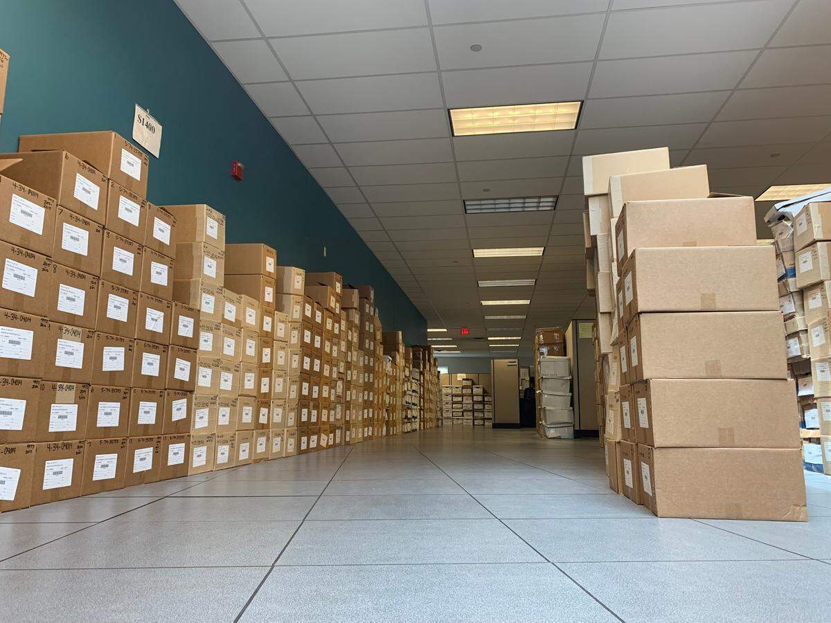 Pictured are boxes containing out-of-business records of Federal Firearms Licensees (FFLs) that have discontinued business and shipped their firearm transactions records to the ATF National Tracing Center. These boxes are awaiting processing, so ATF can access them if a firearm trace request is received for a firearm that passed through that FFL while they were in business.