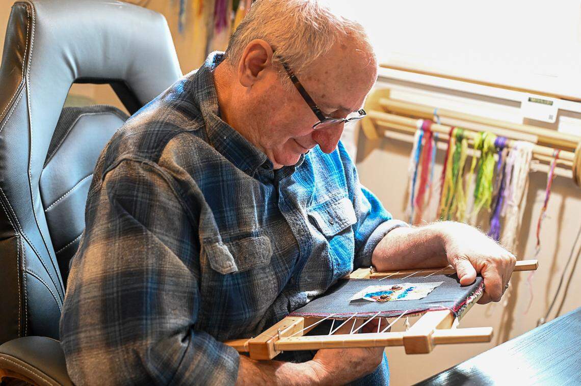Martin Matisoff works on a piece of embroidery in the studio of his Frankfort home. He wears two pairs of glasses to better see the intricate stitching. Sharon Matisoff and Martin Matisoff are visual artists based in Frankfort, Kentucky. They will both be featured in the Kentucky Crafted Market March 9 and 10, 2024 at the Kentucky Horse Park’s Alltech Arena in Lexington, Kentucky.