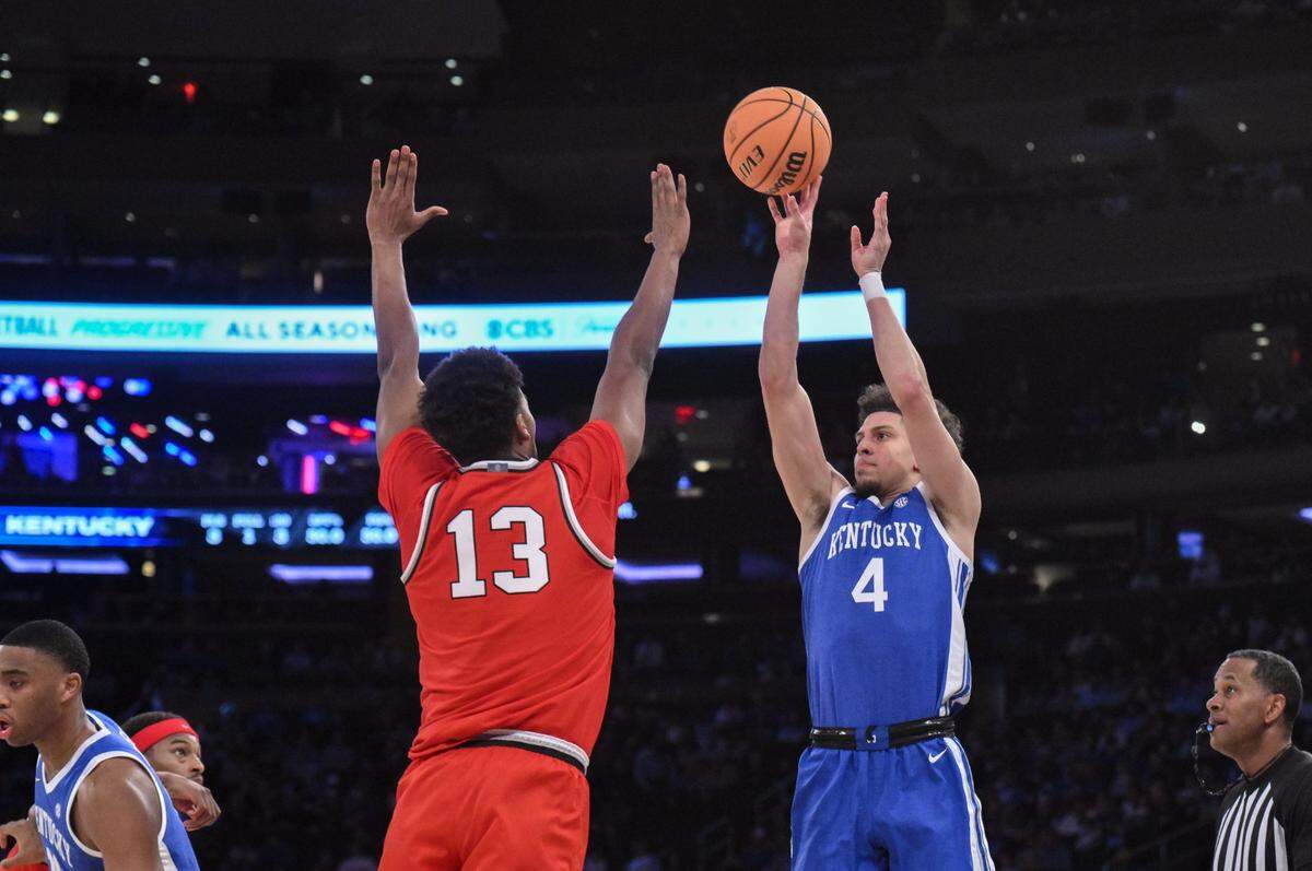 Dec 21, 2024; New York, New York, USA; Kentucky Wildcats guard Koby Brea (4) shoots the ball while being defended by Ohio State Buckeyes forward Sean Stewart (13) during the first half at Madison Square Garden. Mandatory Credit: John Jones-Imagn Images