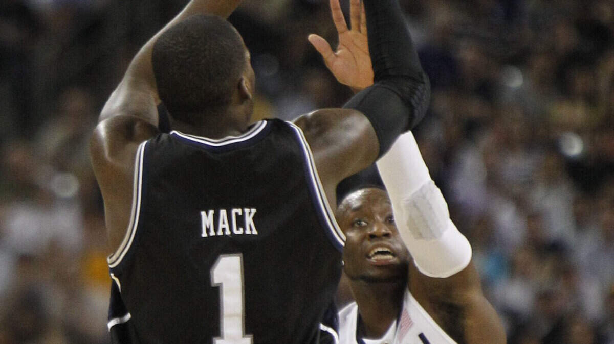 Butler guard Shelvin Mack put up a shot in front of Connecticut's Donnell Beverly in the first half of the championship game Monday night in Houston.  