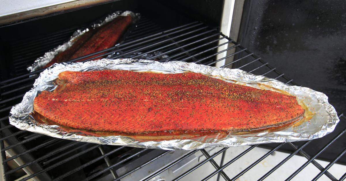 Michael Yessin pulled out a large piece of salmon he was cooking outside his Lexington Seafood Co. in 2013.
