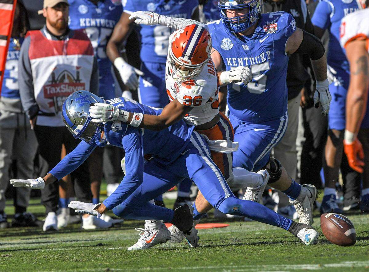 Clemson safety Khalil Barnes (36) knocks the ball loose from Kentucky receiver Barion Brown during the fourth quarter of the TaxSlayer Gator Bowl at EverBank Stadium in Jacksonville, Florida.