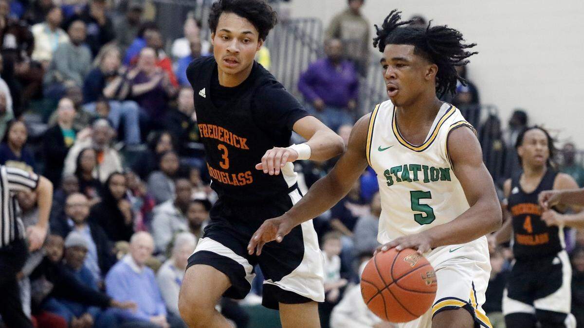 Bryan Station’s Amari Owens (5) drives on Frederick Douglass’ DeMarcus Surratt (3) during a game on Jan. 26.