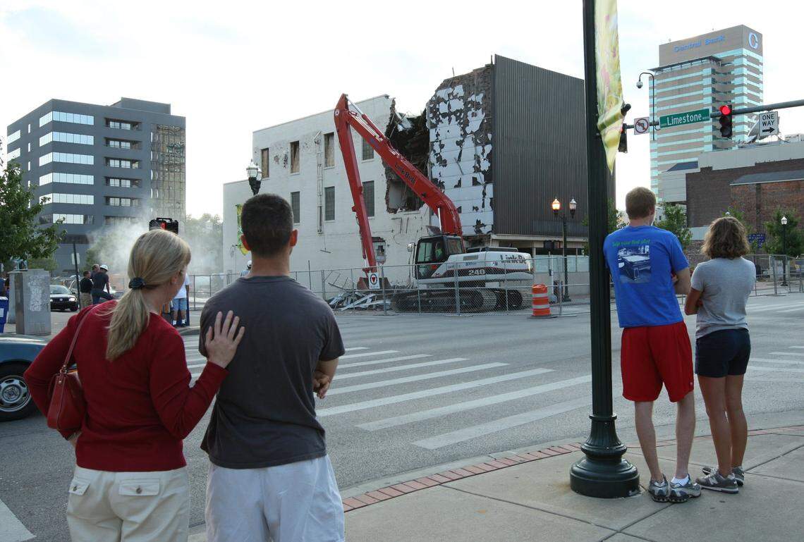 Mary Beth Navmann and Kevin Compton, left, and Brent Roach and Elizabeth Browning, watch members of the Diversified Demolition crew tear down the old Rite Aid building at the corner of Limestone and Main Street in Lexington, Ky., on Wednesday, July 23, 2008. The building was being demolished to make way for the proposed CentrePointe development. Photo by David Stephenson | Staff 6223