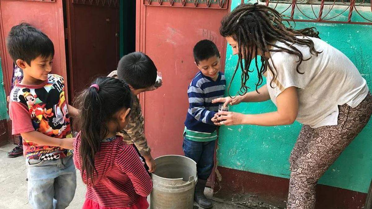 Reina Slaymaker, who grew up in Lexington, helped her students at the Little Mountain School plant seeds.