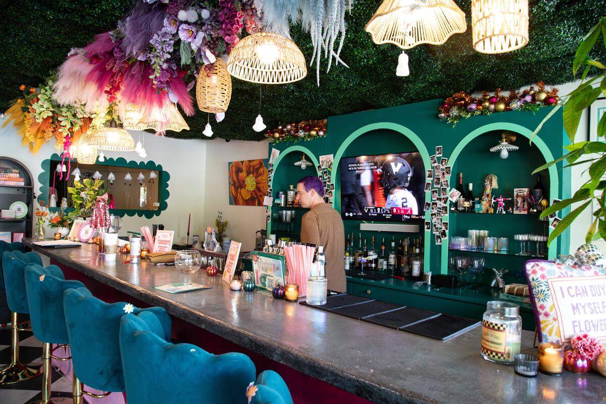 Bartender Jake Terry serves clients alcoholic beverages, cocktails, and colorful moctails at Poppy’s Flower Bar during private events and while building bouquets on Oct. 4, 2025, in Lexington, Ky.