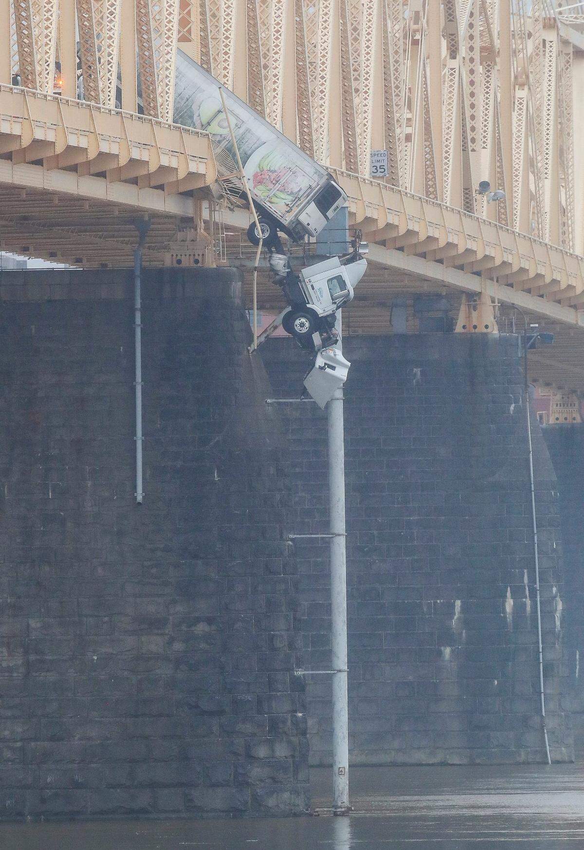 A tractor trailer is hanging over the Ohio River following a collision on the Clark Memorial Bridge. Louisville Fire Chief Brian O'Neill said the driver of the trailer was rescued from the cabin at 12:45 p.m. Friday, about 45 minutes after the collision occurred. March 1, 2024
