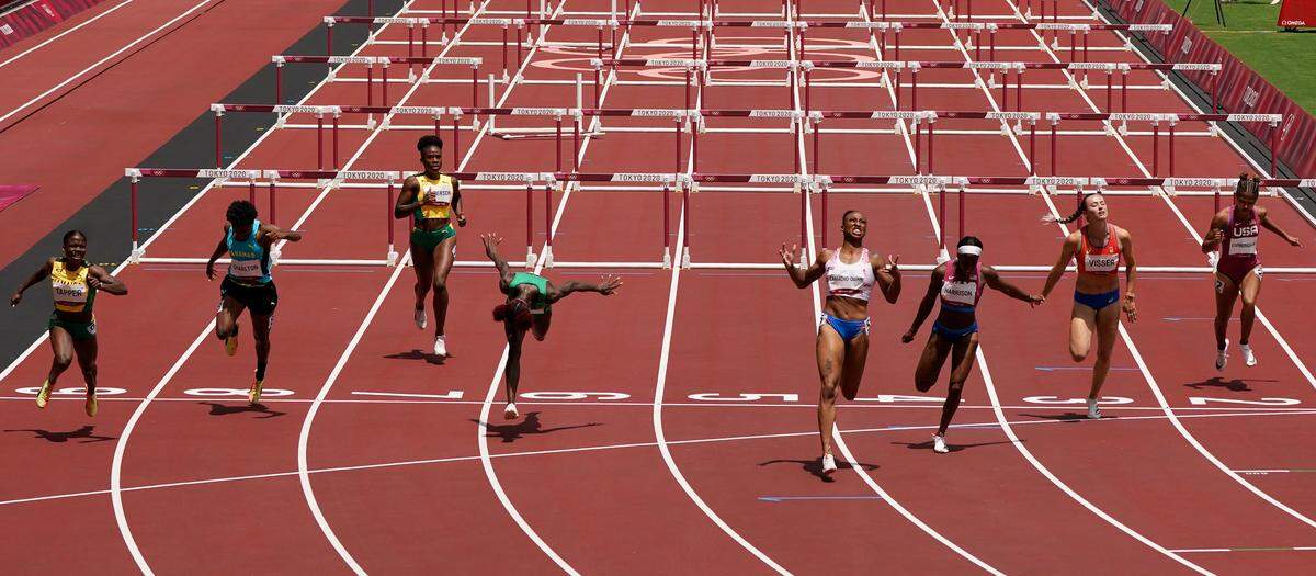 Jasmine Camacho-Quinn, fourth from right, celebrated after winning the gold medal in the women’s 100-meters hurdles ahead of silver-medal winner Kendra Harrison, third from right, and bronze-medal winner Megan Tapper, left, at the Olympics.