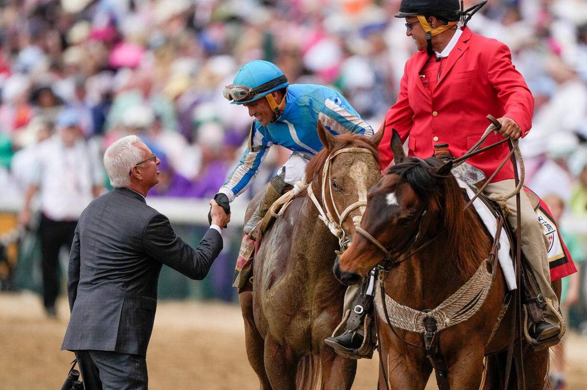 Todd Pletcher — trainer for Kingsbarns, Tapit Trice and the scratched favorite, Forte — congratulates Javier Castellano for his win aboard Mage.