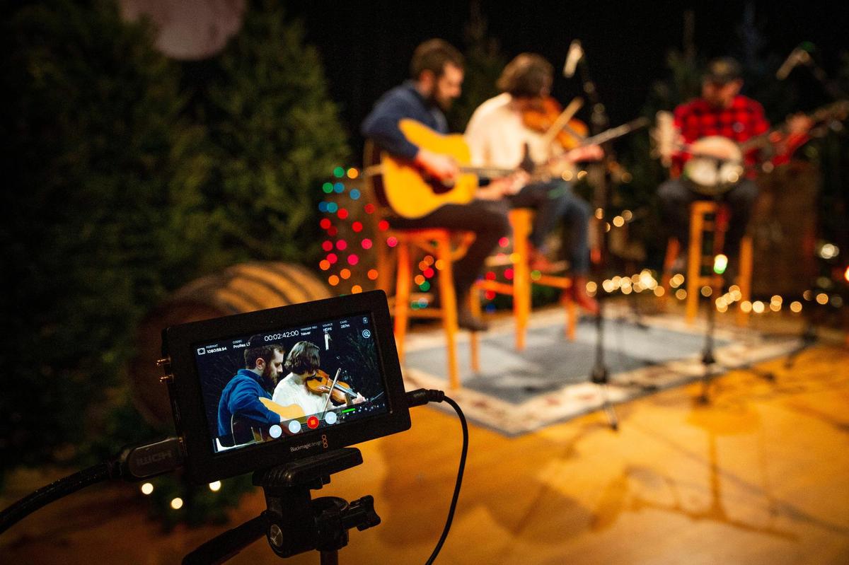 The Wells family, including Carrie Wells, center, her husband Matthew, left, and her brother, Jesse, right, perform during the taping of Red Barn Radio’s Christmas special, An Appalachian Christmas, in Lexington, Ky., on Wednesday, Dec. 2, 2020. The Wells are one of three families of musicians to be featured in An Appalachian Christmas.