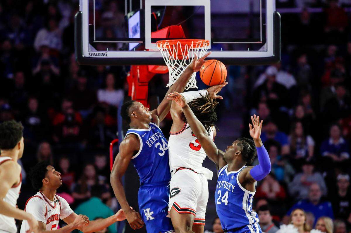 Kentucky forward Oscar Tshiebwe (34) tries to stop Georgia guard Kario Oquendo (3) from scoring during Saturday’s game at Stegeman Coliseum in Athens, Ga.