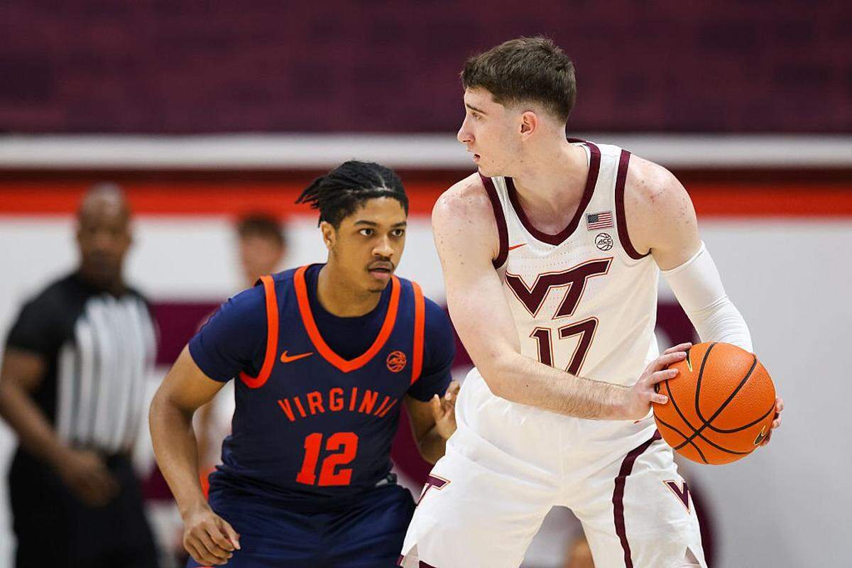 BLACKSBURG, VIRGINIA - DECEMBER 31: Neoklis Avdalas #17 of the Virginia Tech Hokies is defended by Elijah Gertrude #12 of the Virginia Cavaliers in the first half during a game at Cassell Coliseum on December 31, 2025 in Blacksburg, Virginia. (Photo by Ryan Hunt/Getty Images)