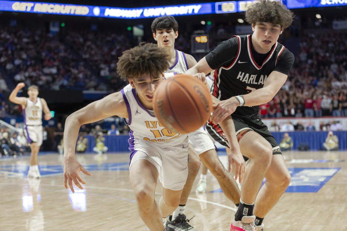 Lyon County’s Bray Kirk (10) and Harlan County’s Maddox Huff reach for a loose ball during the Boys’ Sweet 16 state basketball game.