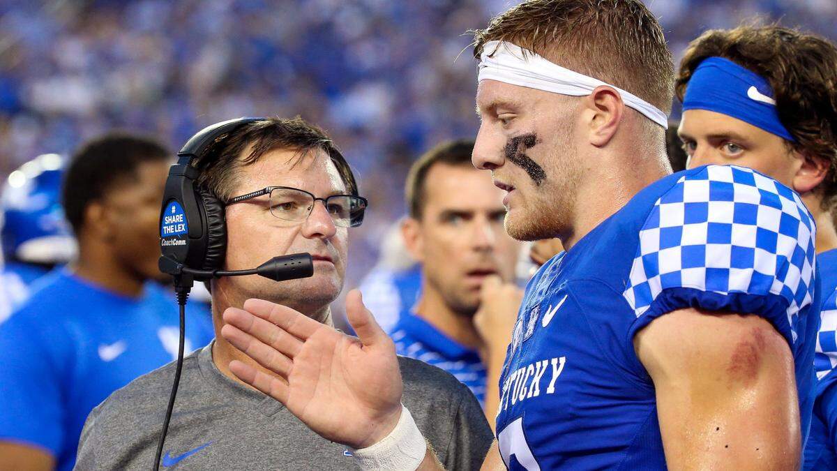 Kentucky offensive coordinator Rich Scangarello, left, talked with quarterback Will Levis (7), right, on the sideline during UK’s 37-13 season-opening win over Miami (Ohio). Through three games in 2022, the Wildcats are averaging 111.7 yards a game in total offense less than they were averaging through three games in 2021.