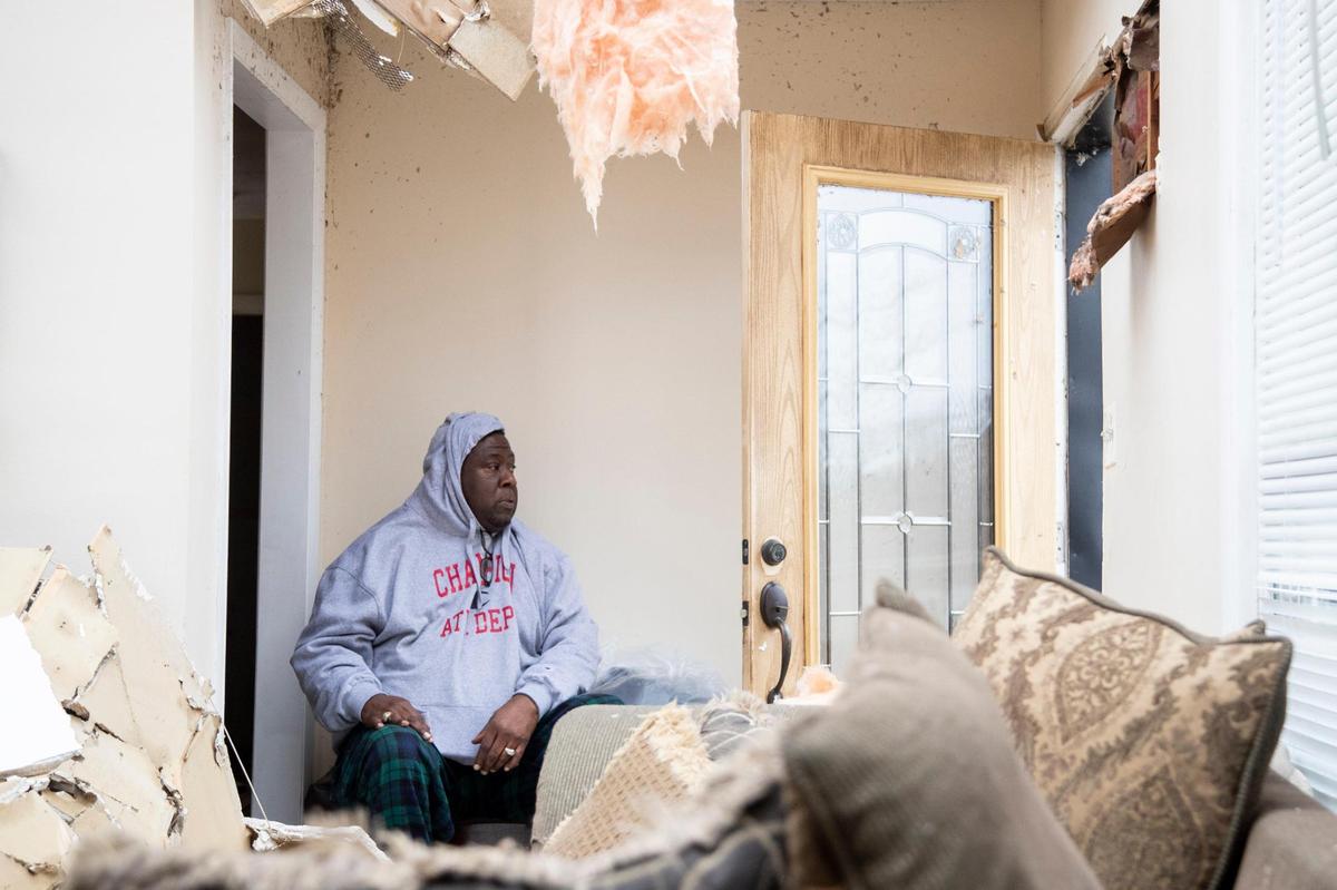 Les McDonald takes a moment while cleaning debris from his home after a tornado took off the roof while passing through his neighborhood in Bowling Green, Ky., Saturday, December 11, 2021. McDonald and other members of his household were inside when the roof was torn off.