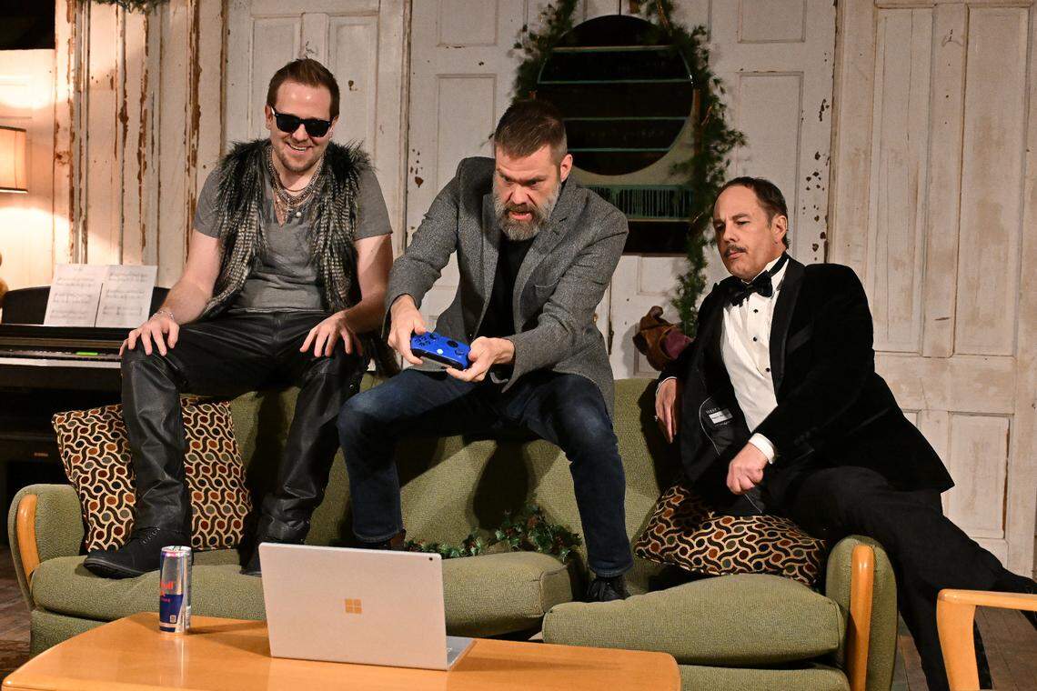 Brothers John (Tanner Grey), Richard (Shayne Brakefield), and Geoffrey (Tim Hull) do battle with a video game. On the Verge Theatre presents “The Lion in Winter” at Luigart Studio, 110 Luigart Court in Lexington, Kentucky, Jan. 23-Feb. 1. This photo was taken at a rehearsal Jan. 17, 2025.