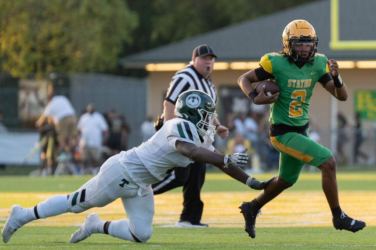 Trinity's Jule'one Carney (8) tackles Bryan Station's James Davis (2) during their game on Friday, Aug. 23, 2024 at Bryan Station High School in Lexington, Ky.