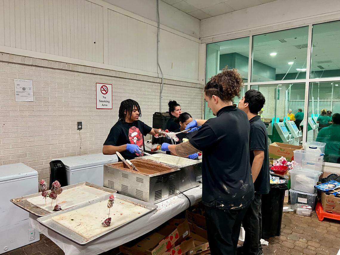 Kentucky Derby workers prepare strawberry and brownie kabobs.
