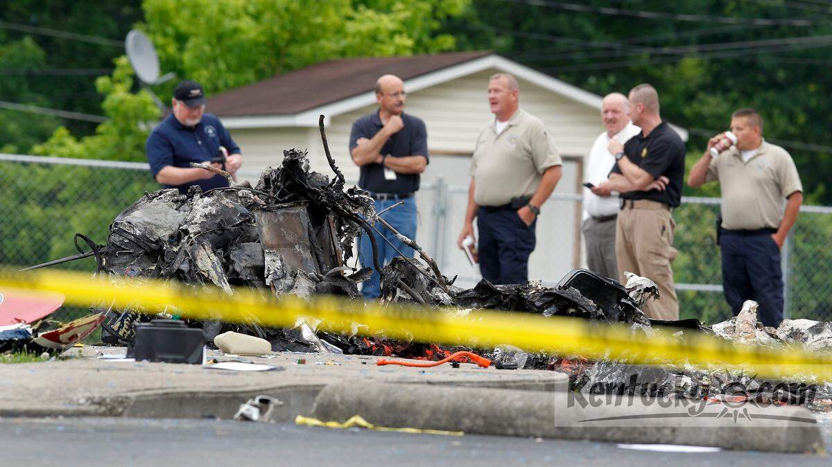 Various officials looked over debris at the scene of a fatal helicopter crash in the parking lot next to Paces Elementary School on U.S. 421 in Manchester, Ky., Friday, June 07, 2013. Eddy Sizemore, a former chief deputy for the Laurel County sheriff's office was among three men killed at 11:16 p.m. Thursday in Manchester when the Air Evac Lifeteam medical helicopter crashed. Also killed were flight paramedic Herman "Lee" Dobbs and flight nurse Jesse Jones, according to Lifeteam. Photo by Charles Bertram | Staff