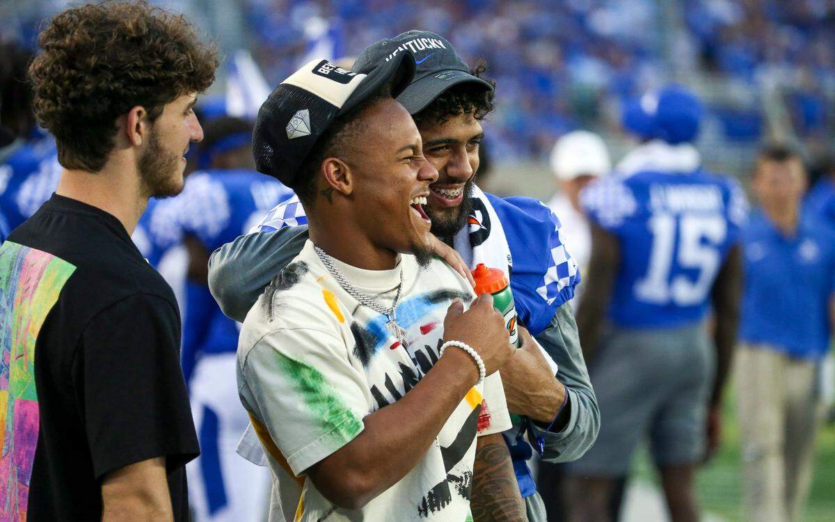 Former Kentucky wide receiver Wan’Dale Robinson, center, laughs on the sidelines during during first half against Miami (Ohio).