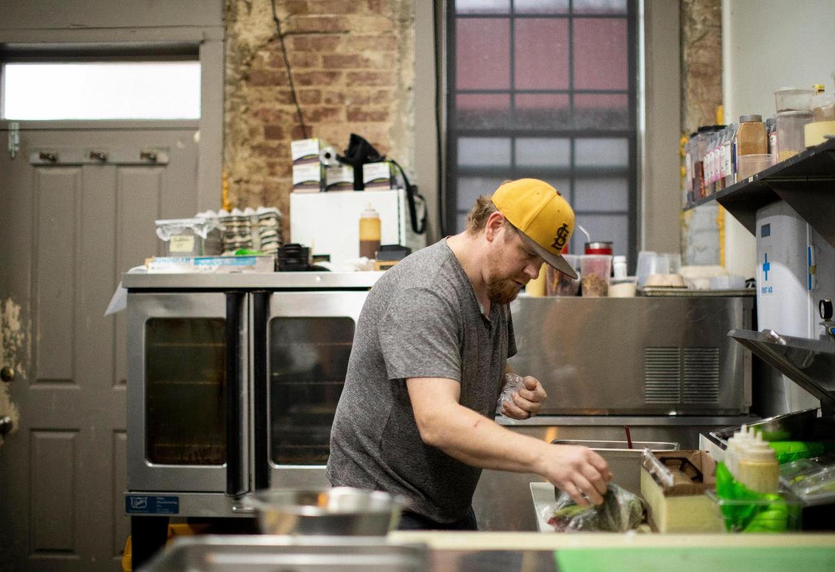 Chef and owner Justin Thompson works in the kitchen creating a dish at his restaurant Local Feed in downtown Georgetown, Nov. 11, 2020. “I’ve always loved it and known this is what I wanted to do,” Thompson said.